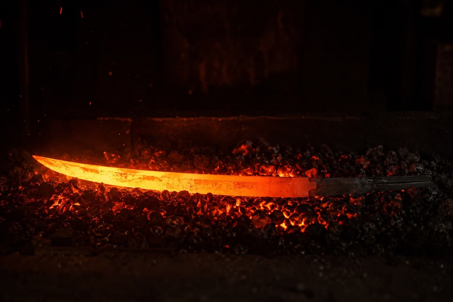 Steel glowing yellow hot beside the forge fire